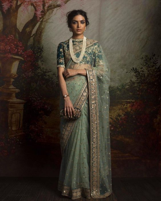 layered pearl contrast jewellery with green saree