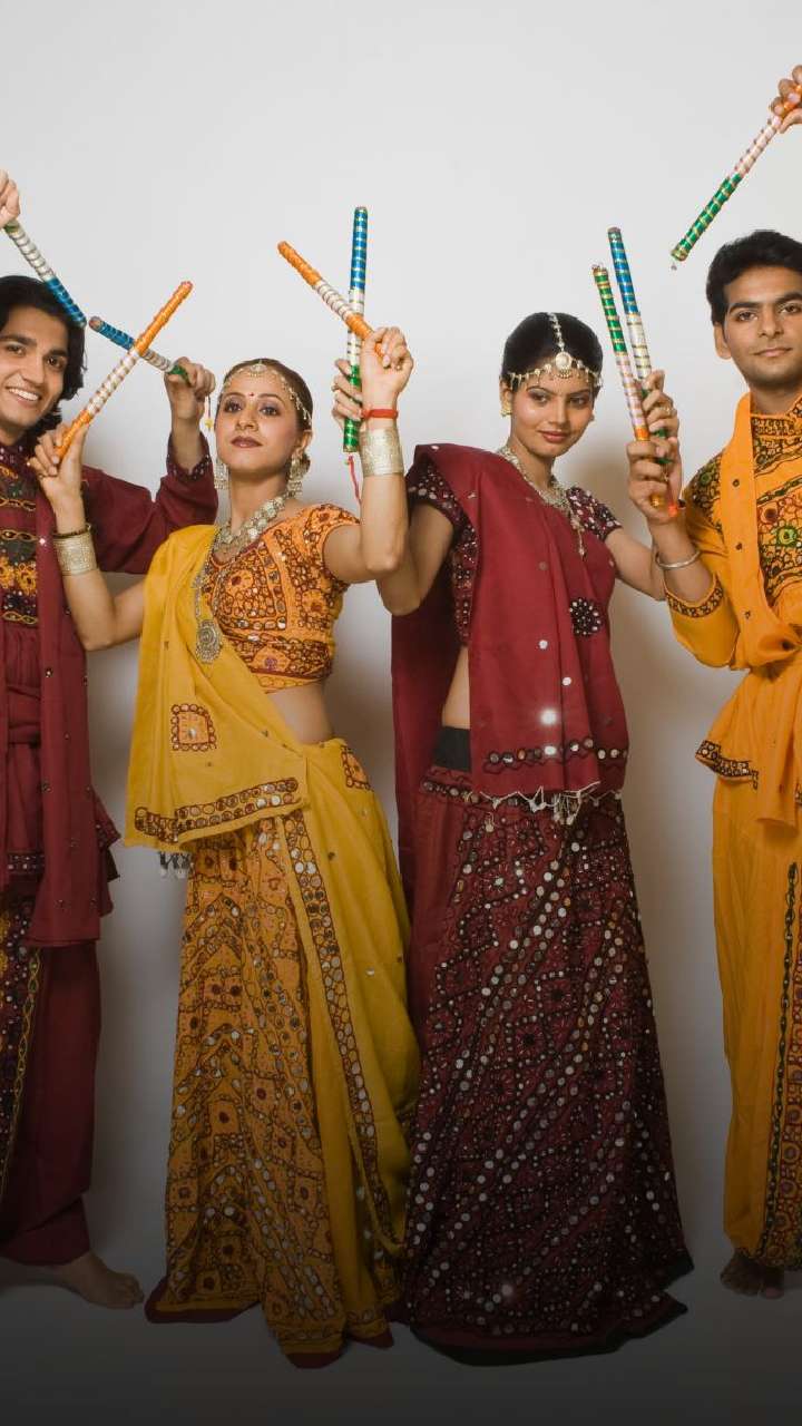 Indian couple playing garba in dandiya night navratri dussehra • wall  stickers music, editable, dress | myloview.com